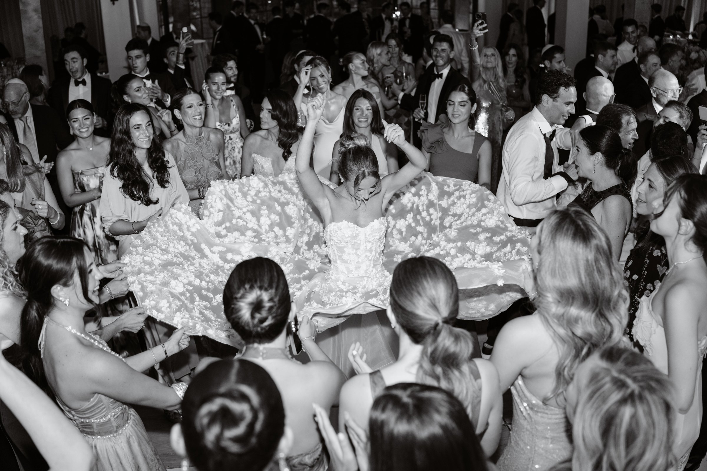 A bride spins on the dance floor as the circle lifts her gown