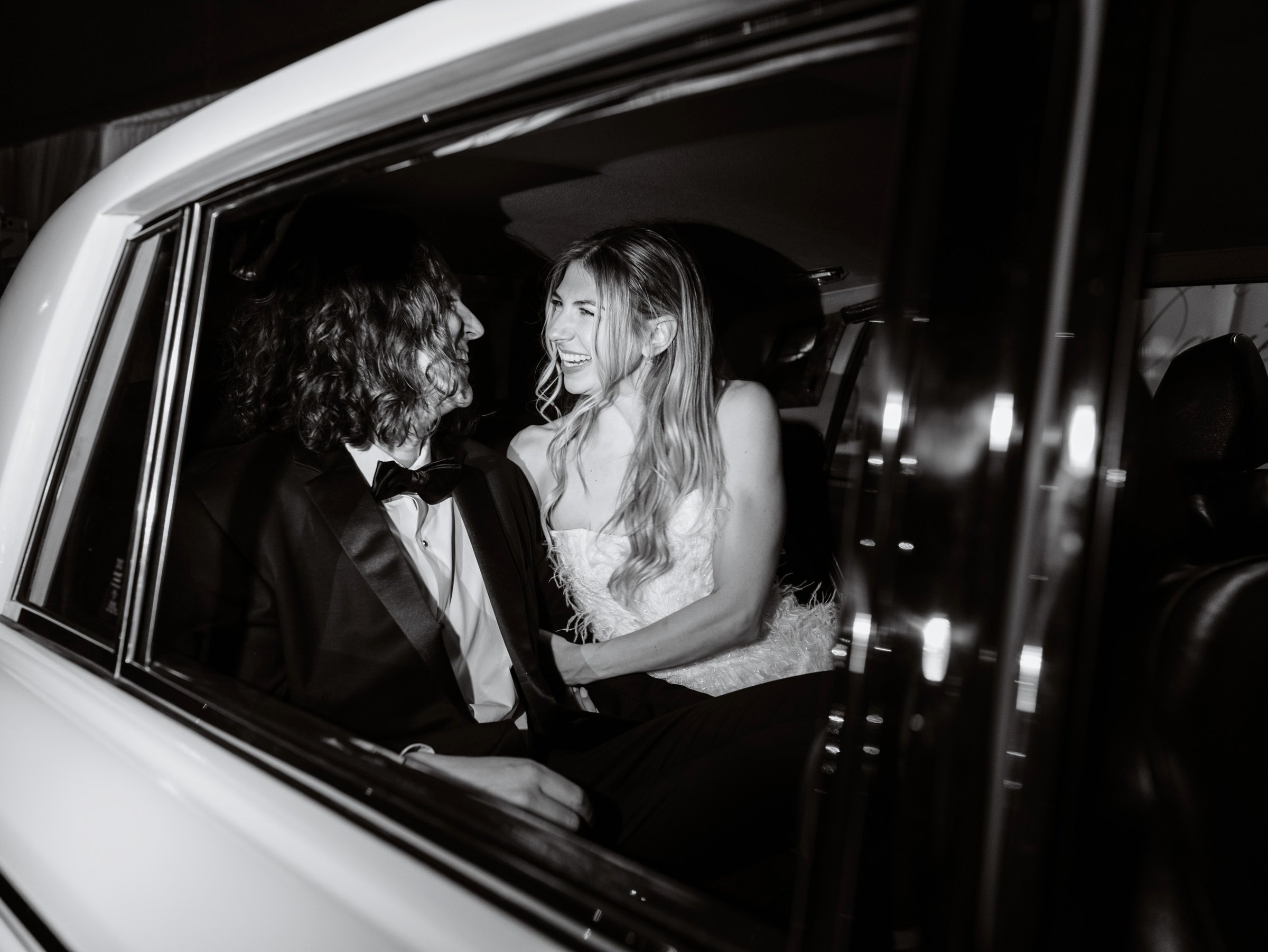 Lauren and Daniel laughing in the getaway car