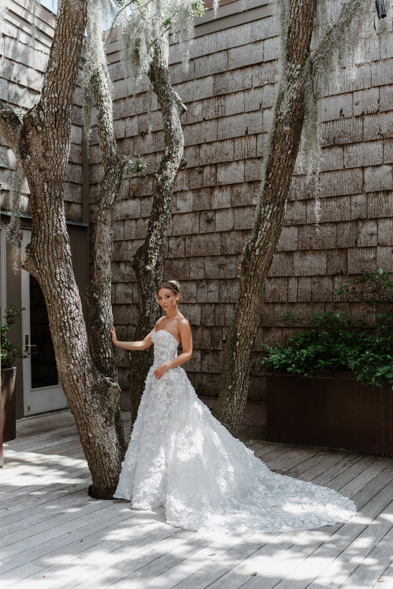 Paige in her floral gown beneath the live oaks