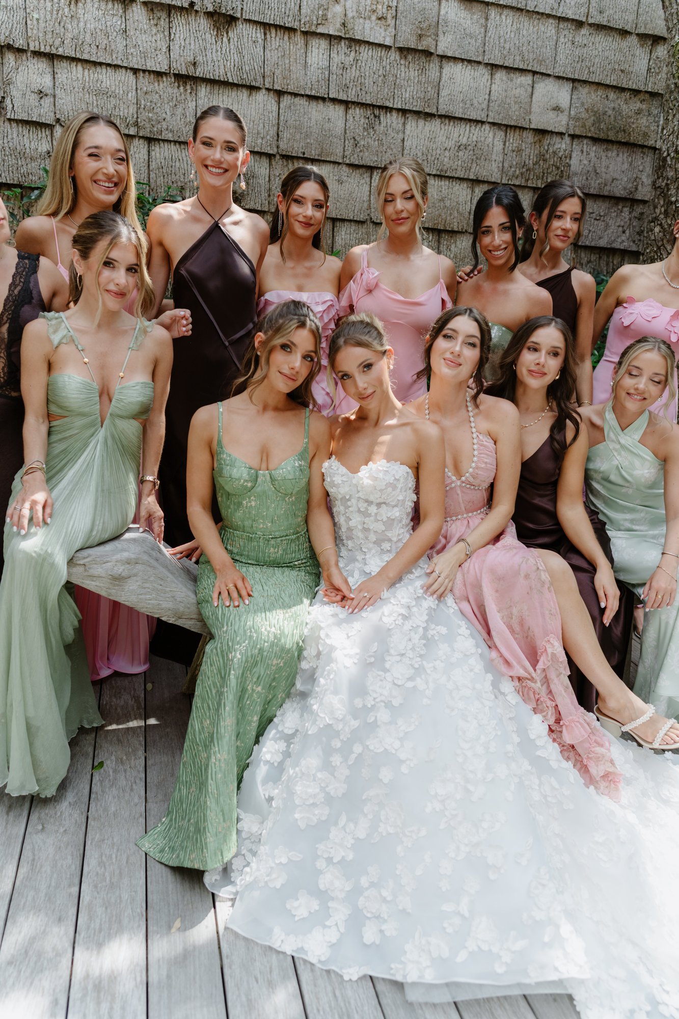 Paige with her bridesmaids in greens and pinks