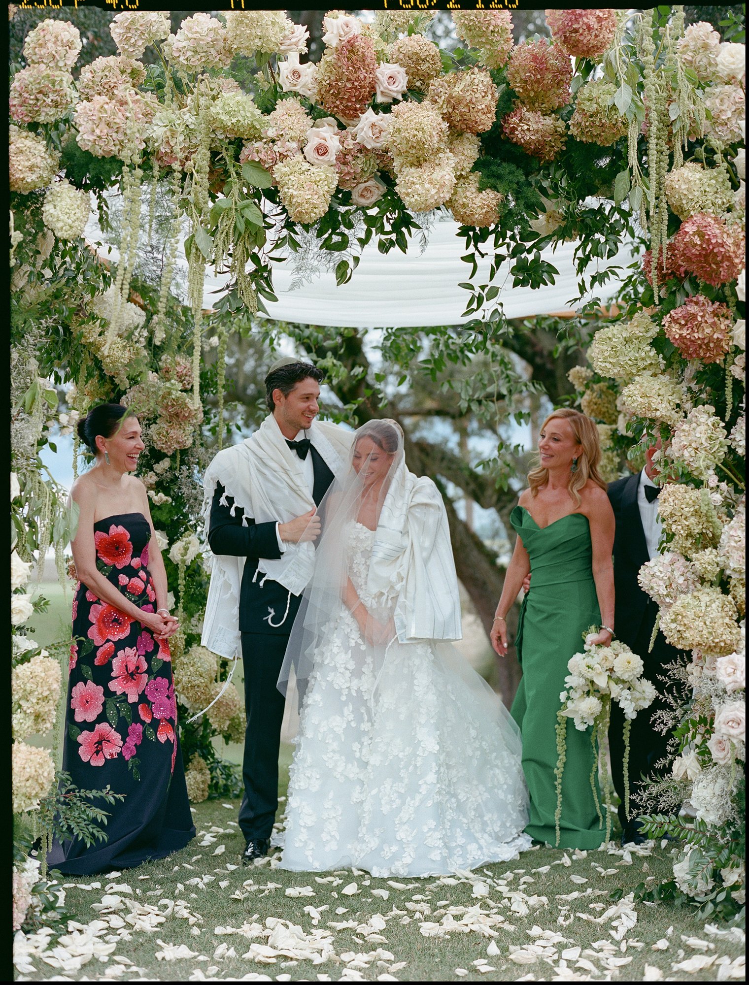 Paige and Jake with their mothers beneath the chuppah